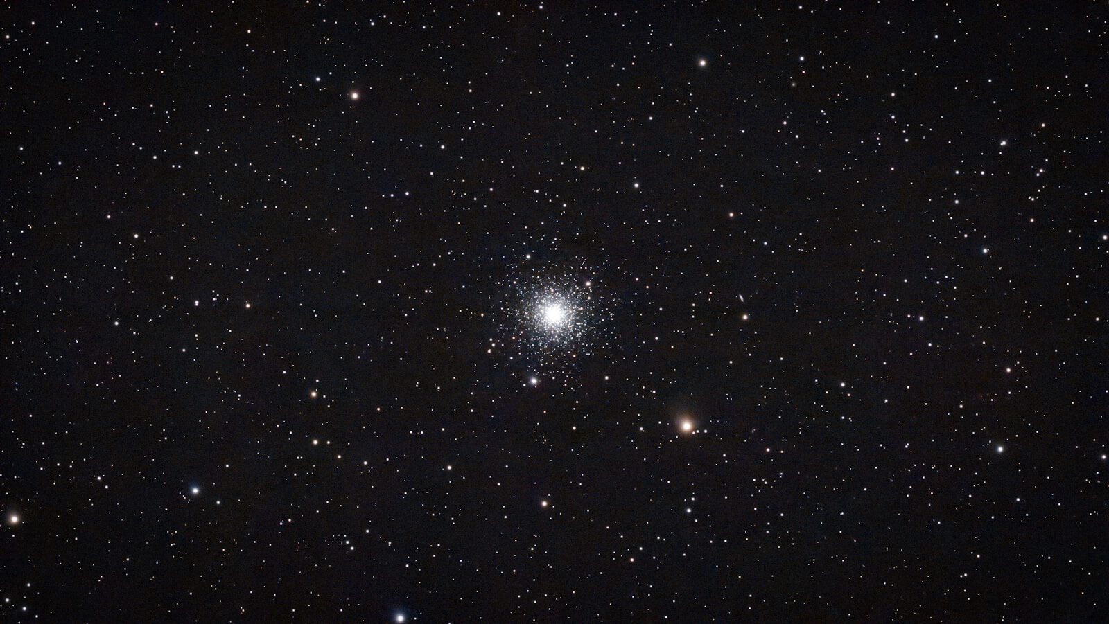 A dense star cluster in the night sky.